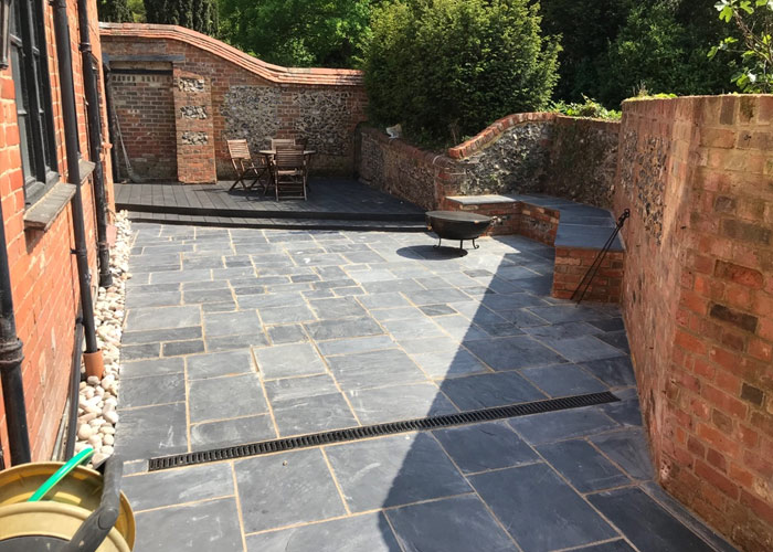 Design and build of a converted courtyard space
						using Indian sandstone and Millboard decking in Woodley, Reading